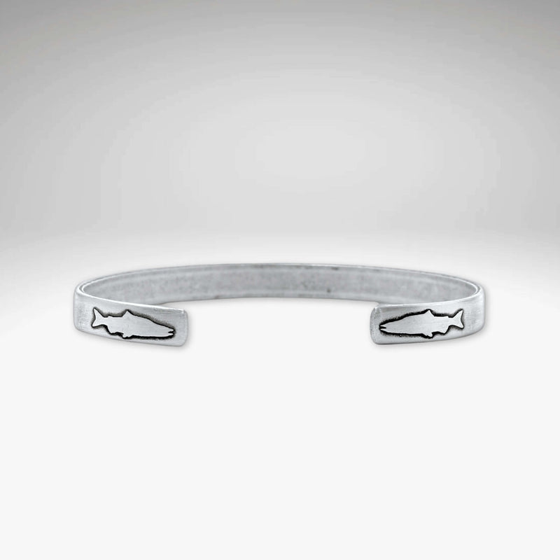 Skinny Fish Cuff Bracelet with etched fish design on tips, showcasing raw brass texture and stylish appeal.
