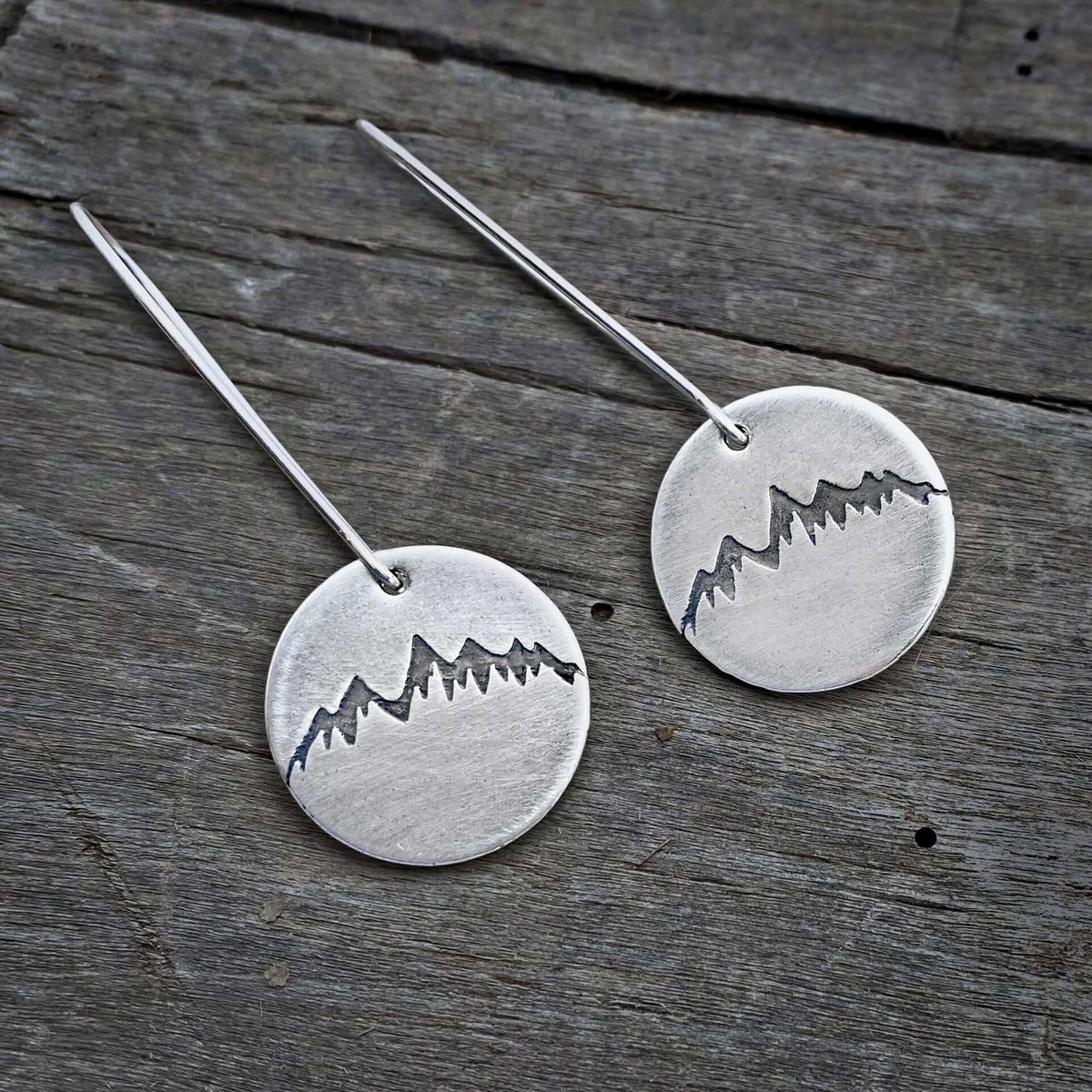 Snowcap Mountain Earrings featuring snowcapped mountain peaks on elegant round disks with kidney earwires.