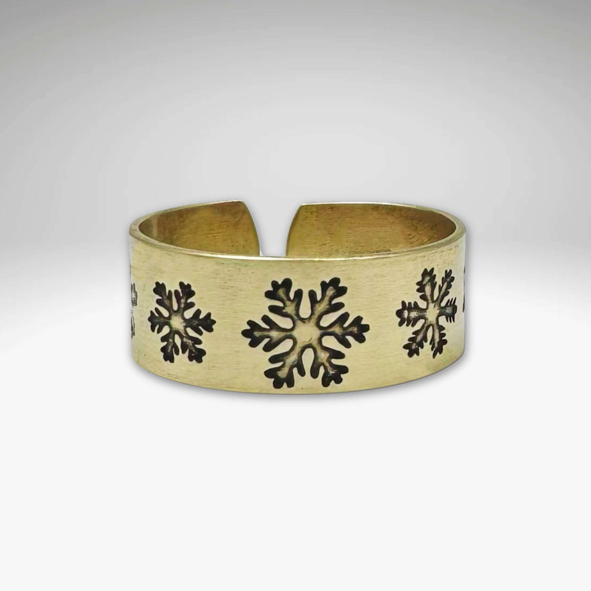 Snowfall Adjustable Ring in Antique Brass finish featuring unique snowflake designs, adjustable for sizes 7 to 11.