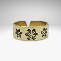 Snowfall Adjustable Ring in Antique Brass finish featuring unique snowflake designs, adjustable for sizes 7 to 11.