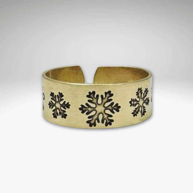 Snowfall Adjustable Ring in Antique Brass finish featuring unique snowflake designs, adjustable for sizes 7 to 11.