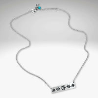 Snowfall Necklace showcasing elegant snowflake bar design on a silver chain, perfect for winter lovers.