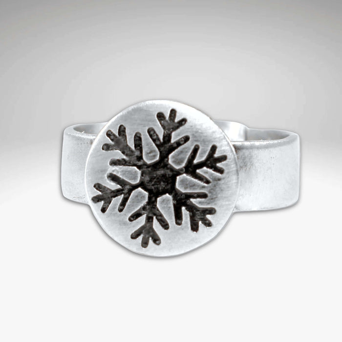 Snowflake Adjustable Ring featuring a handmade snowflake design on a 1/2" disk and adjustable band.