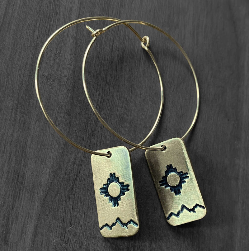 Sol Hoop Earrings featuring Zia sun design in raw brass with hoop-style earwires for a beautiful gift.