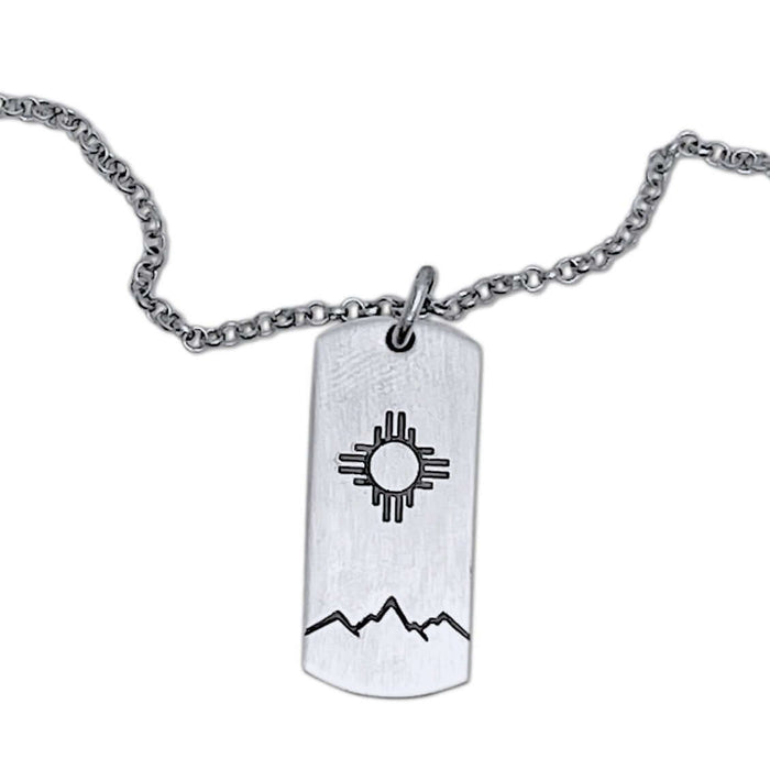 Sol Necklace showcasing Zia sun design etched on a silver pendant, perfect accessory for any outfit.