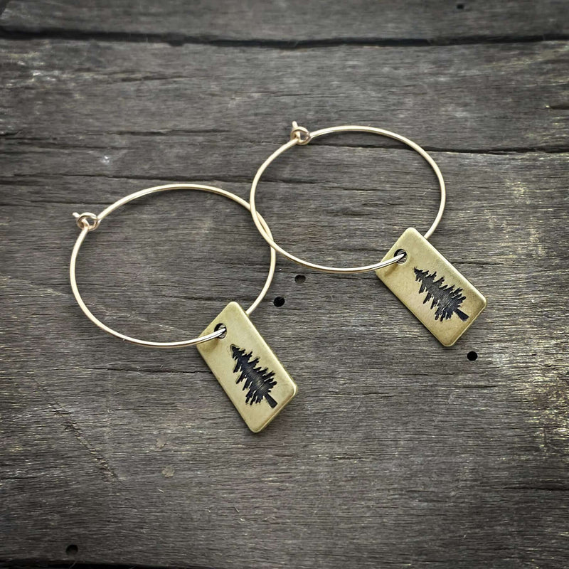 Spruce Tree Hoop Earrings with antique brass finish hanging on simple hoops, perfect for forest lovers.