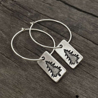 Spruce Tree Hoop Earrings featuring a small spruce tree design on sterling silver hoops.