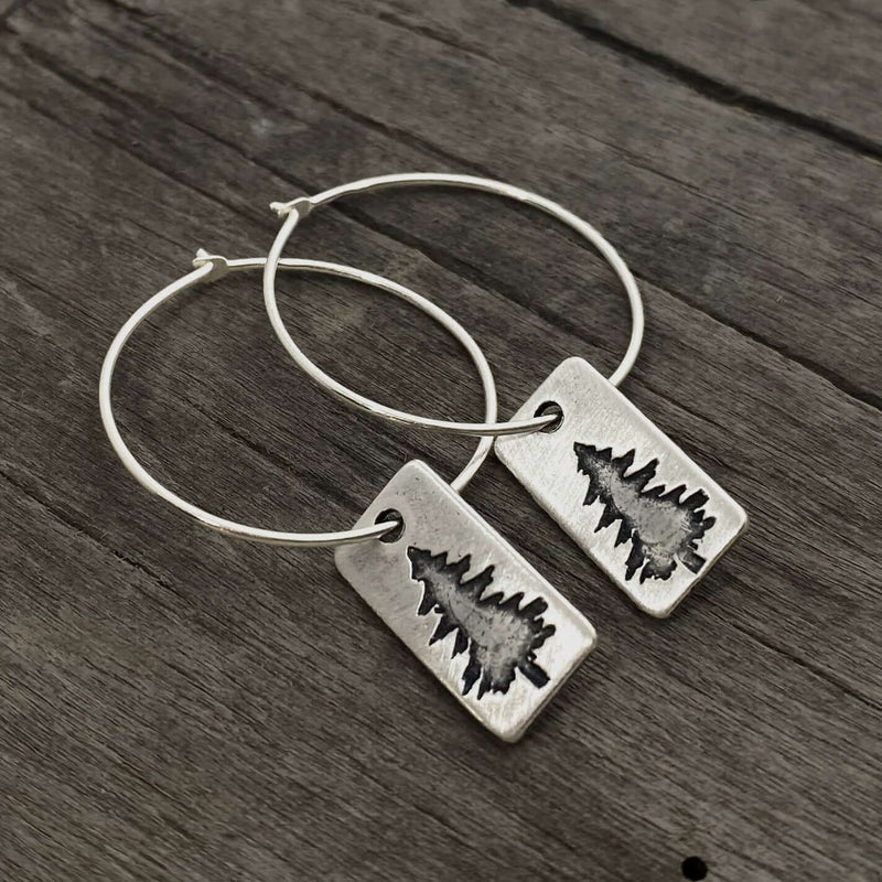 Spruce Tree Hoop Earrings featuring a small spruce tree design on sterling silver hoops.