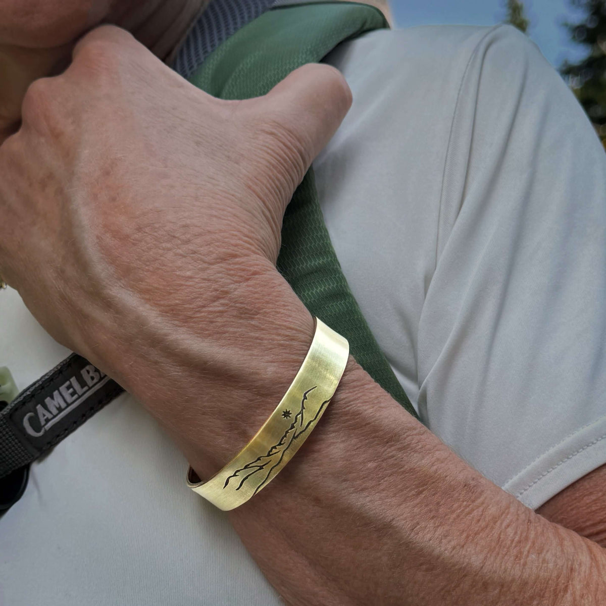 St. Mary Cuff Bracelet worn on a wrist with a nature-inspired design, perfect for nature lovers and Glacier National Park enthusiasts.