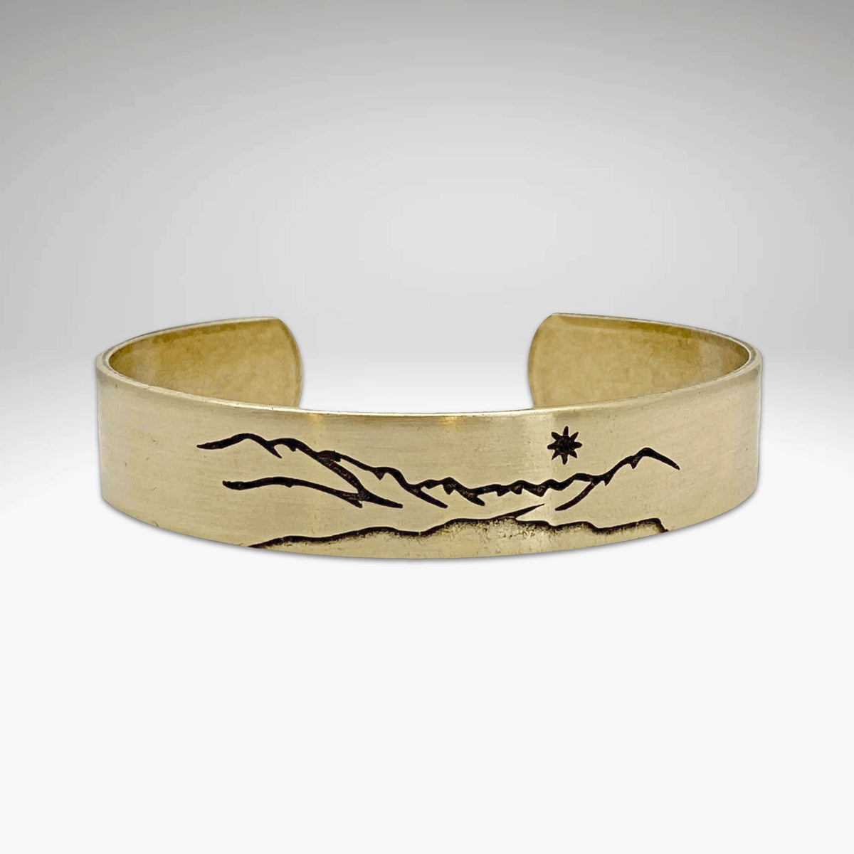 St. Mary Cuff Bracelet featuring mountain and star design, showcasing nature-inspired elegance and adjustable fit.
