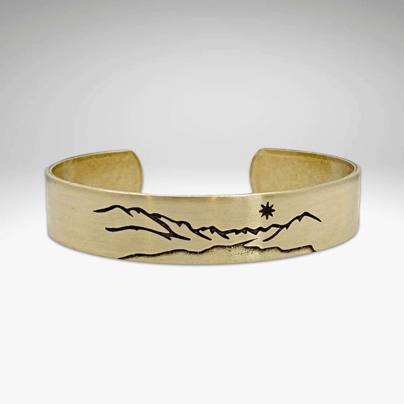 St. Mary Cuff Bracelet featuring mountain and star design, showcasing nature-inspired elegance and adjustable fit.