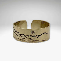 St. Mary Lake Adjustable Ring showcasing intricate mountain design, available in Antique Brass finish.
