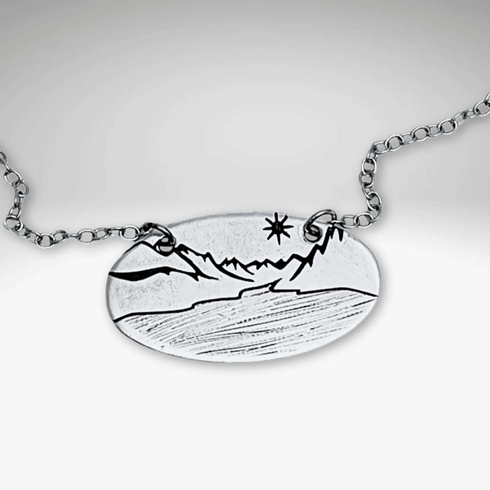 St. Mary Lake in Glacier Necklace featuring intricate mountain and lake design on a silver cable chain.