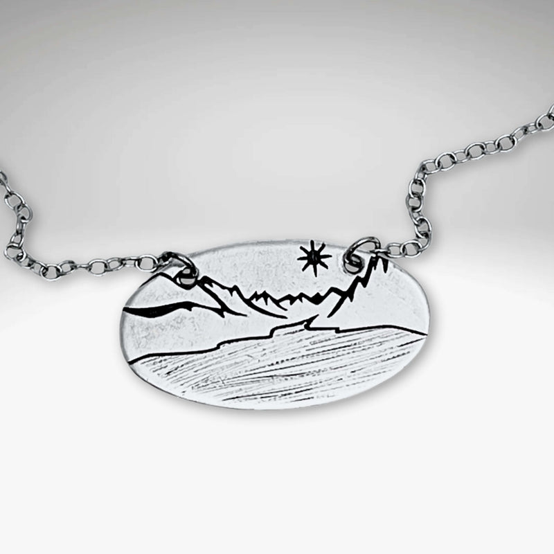 St. Mary Lake in Glacier Necklace featuring intricate mountain and lake design on a silver cable chain.