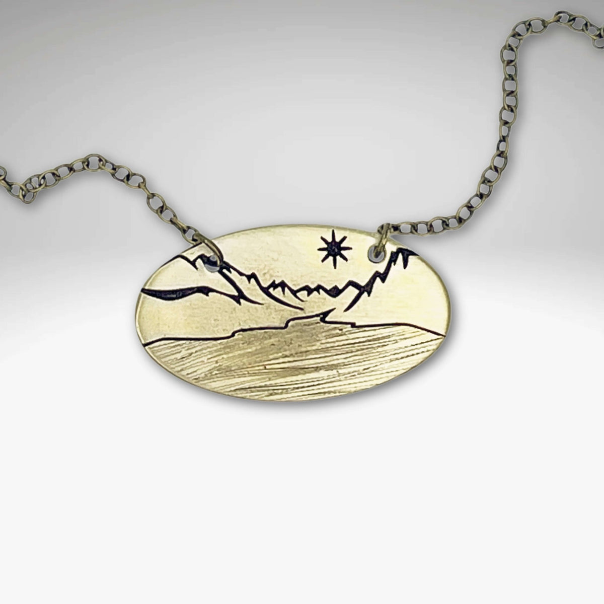 St. Mary Lake in Glacier Necklace featuring intricate landscape design in Antique Brass finish.