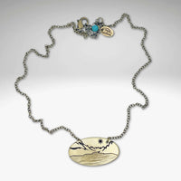 St. Mary Lake in Glacier Necklace featuring a unique design with a cable chain and an engraved oval pendant.