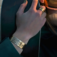 Steelhead Cuff Bracelet worn on a hand, showcasing its unique steelhead design and perfect for fishing enthusiasts.