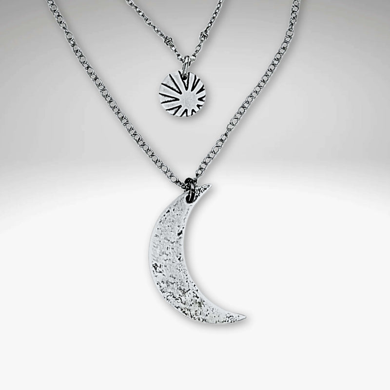 Sun and Moon Long Layered Necklace featuring a hammered crescent moon and sun charm in matte silver.