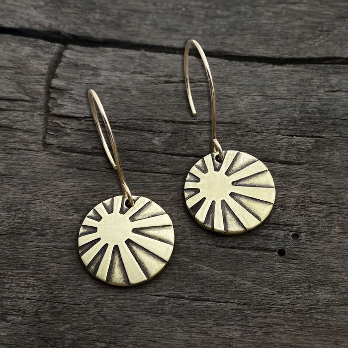 Sunrays Earrings in antique brass, featuring round discs with sunray design on simple earwires.