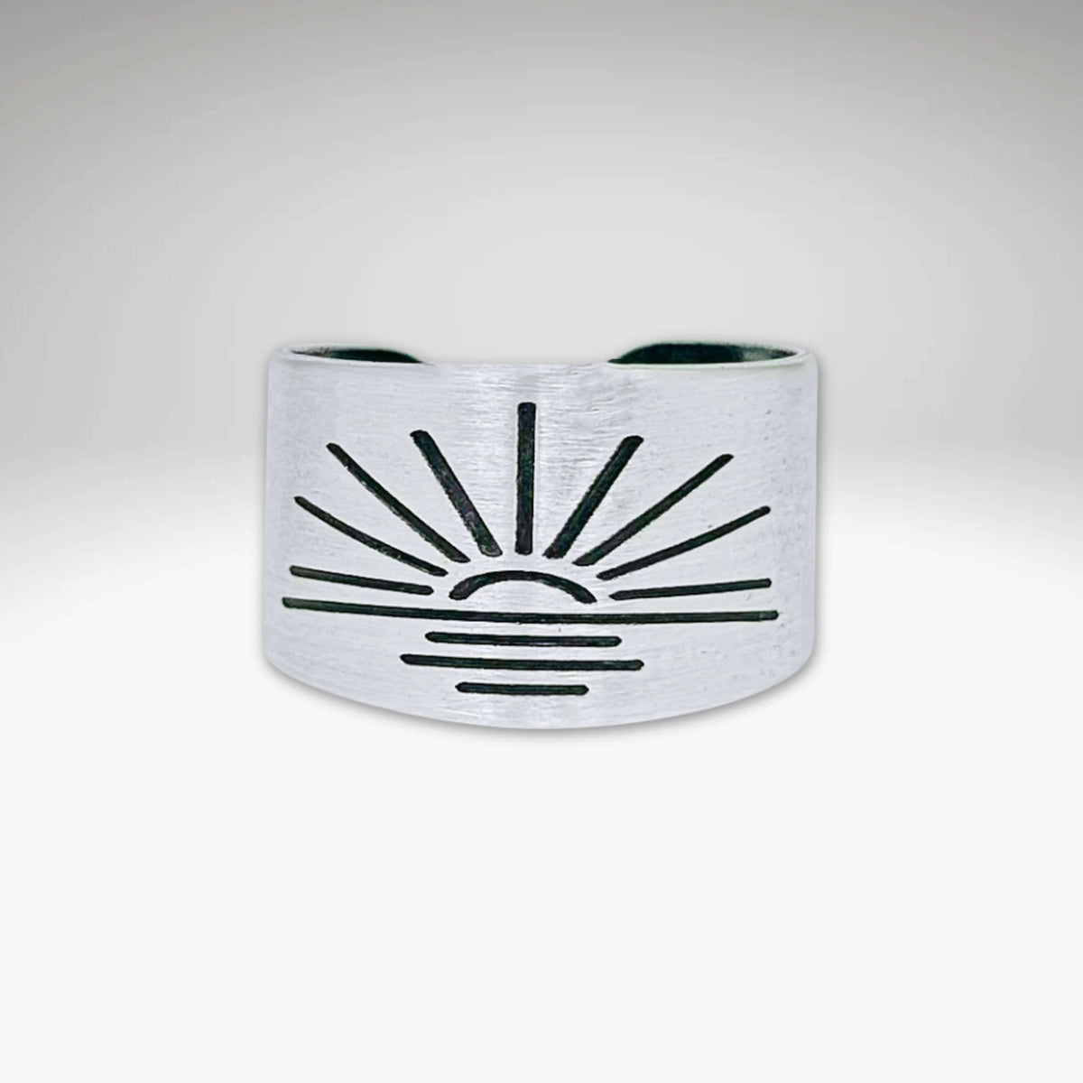 Sunrise Adjustable Ring in matte silver finish with sunburst design, showcasing handcrafted details.
