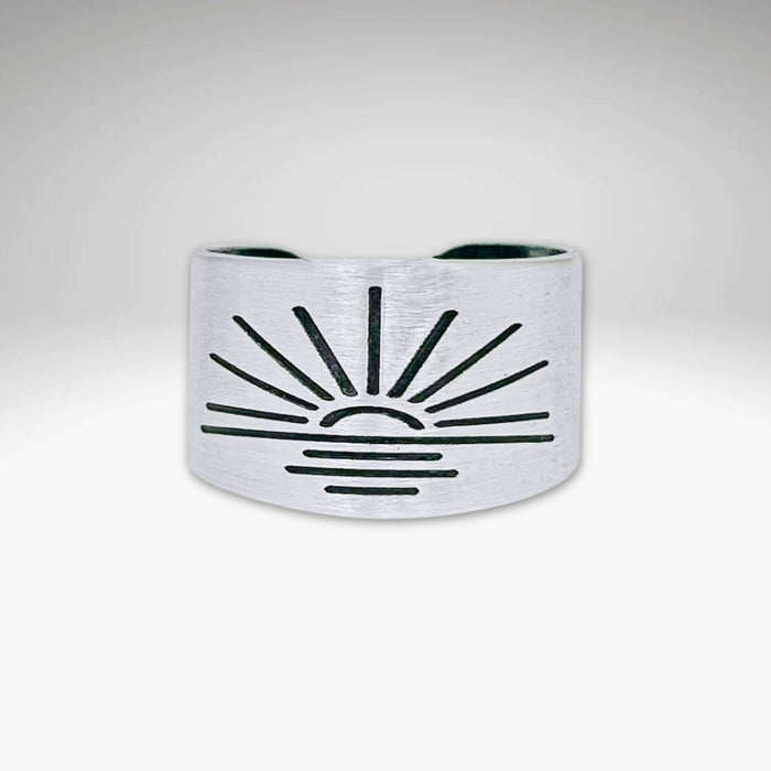 Sunrise Adjustable Ring in matte silver finish with sunburst design, showcasing handcrafted details.