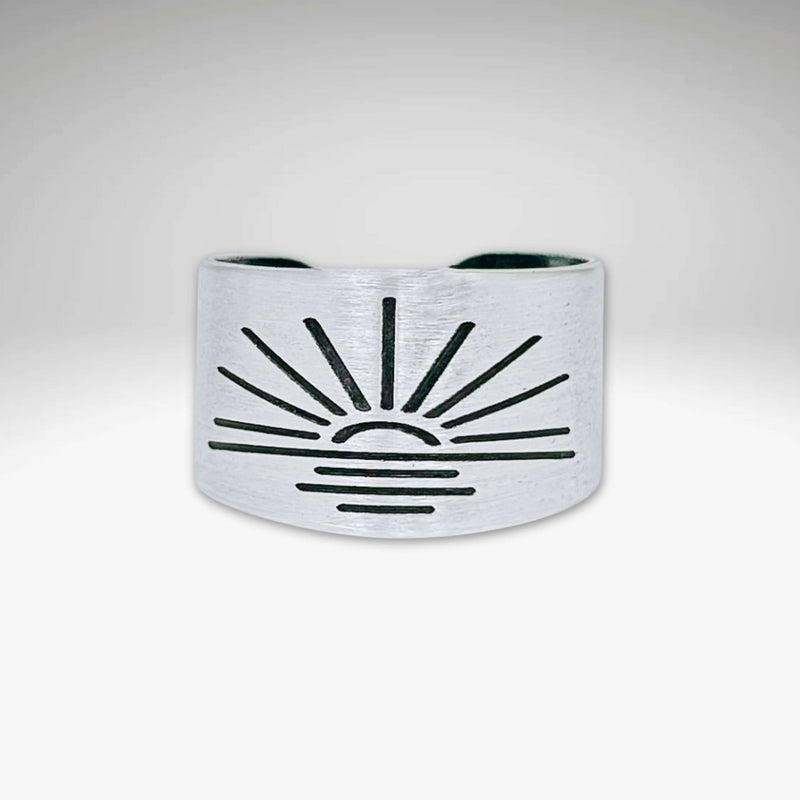 Sunrise Adjustable Ring in matte silver finish with sunburst design, showcasing handcrafted details.