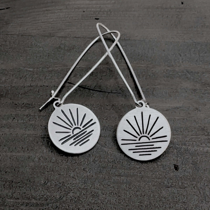 Sunrise Earrings featuring a etched disc design of a sunrise on kidney earwires.