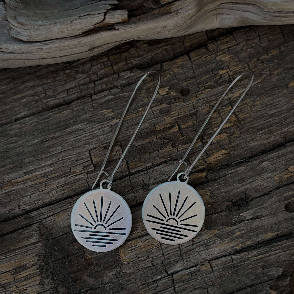 Sunrise Earrings featuring etched sun design on small disc with kidney earwires, perfect for adding elegance to any outfit.