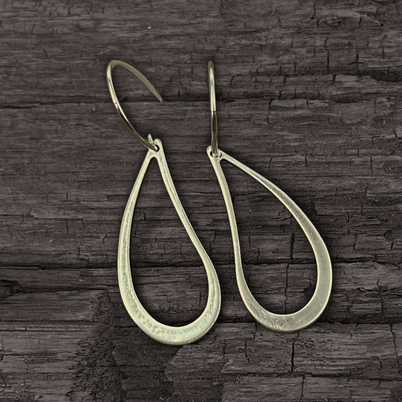 Teardrop Earrings made of solid brass with a hand hammered finish, showcasing an asymmetrical teardrop shape.