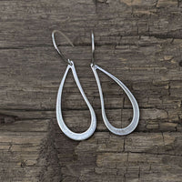 Teardrop Earrings made of solid brass featuring an open asymmetrical design in matte silver finish.