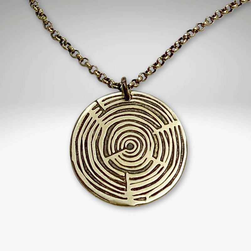 Timber Necklace featuring a round pendant with concentric circles on an adjustable chain.
