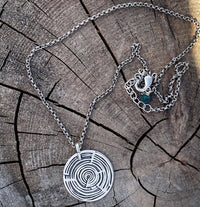 Timber Necklace featuring a circular wood grain design, adjustable silver chain, ideal for nature lovers.