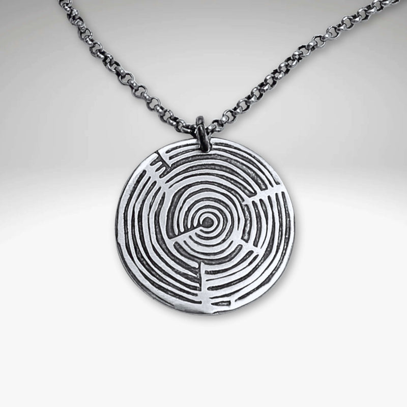 Timber Necklace featuring a circular pendant with concentric growth ring designs, available on adjustable chain or cord.