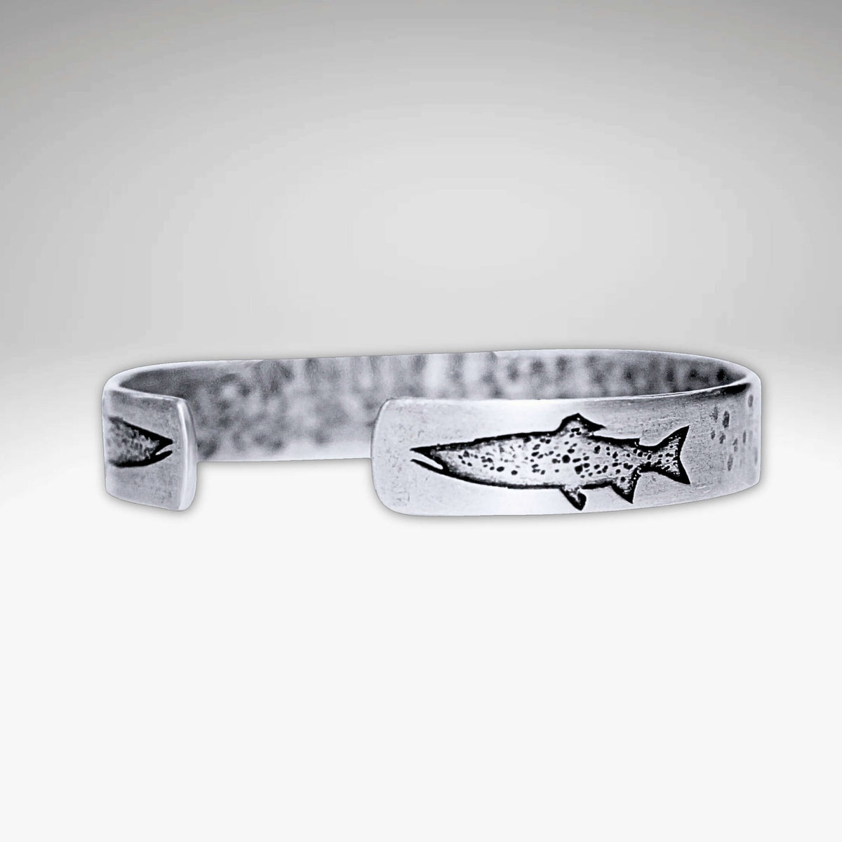 Trout on Tips Cuff Bracelet featuring an etched trout design, handmade and adjustable for both men and women.