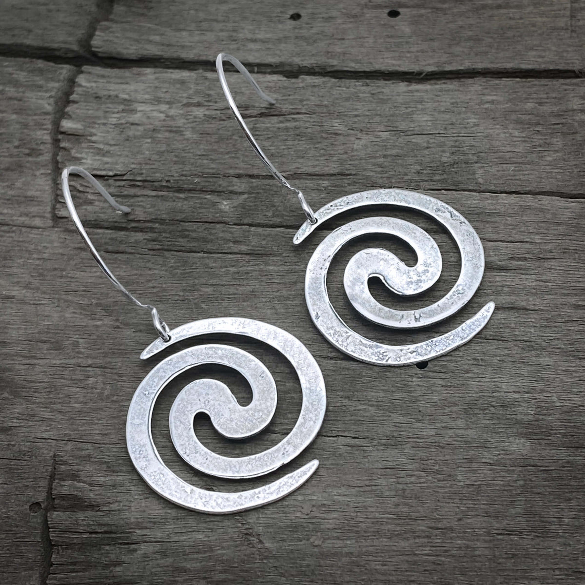 Vortex Earrings in matte silver, 1" spiral design, perfect for outdoor adventures or nightlife.