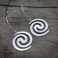 Vortex Earrings in matte silver, 1" spiral design, perfect for outdoor adventures or nightlife.