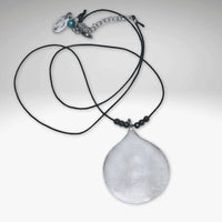 Waterdrop Necklace featuring a hammered pendant on a delicate silk cord with hematite beads.