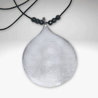 Waterdrop Necklace featuring a larger geometric droplet pendant on delicate silk cord with hematite beads.