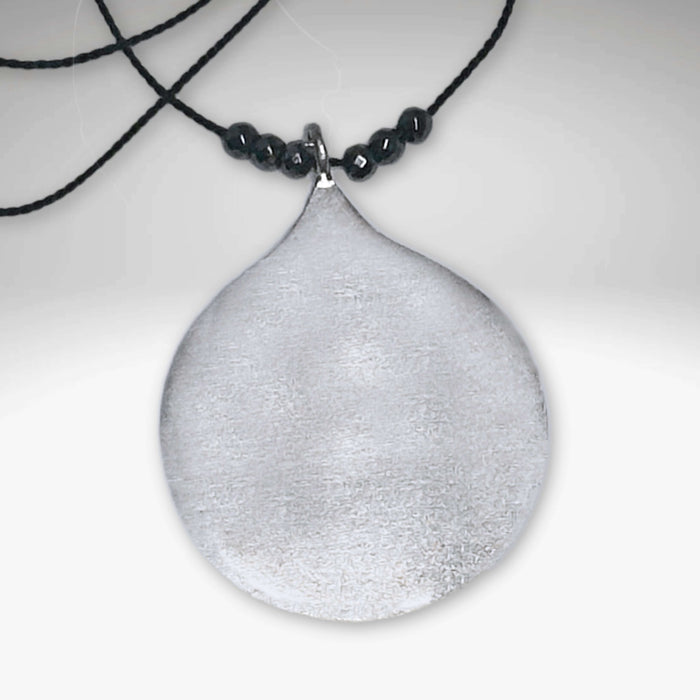 Waterdrop Necklace featuring a larger geometric droplet pendant on delicate silk cord with hematite beads.