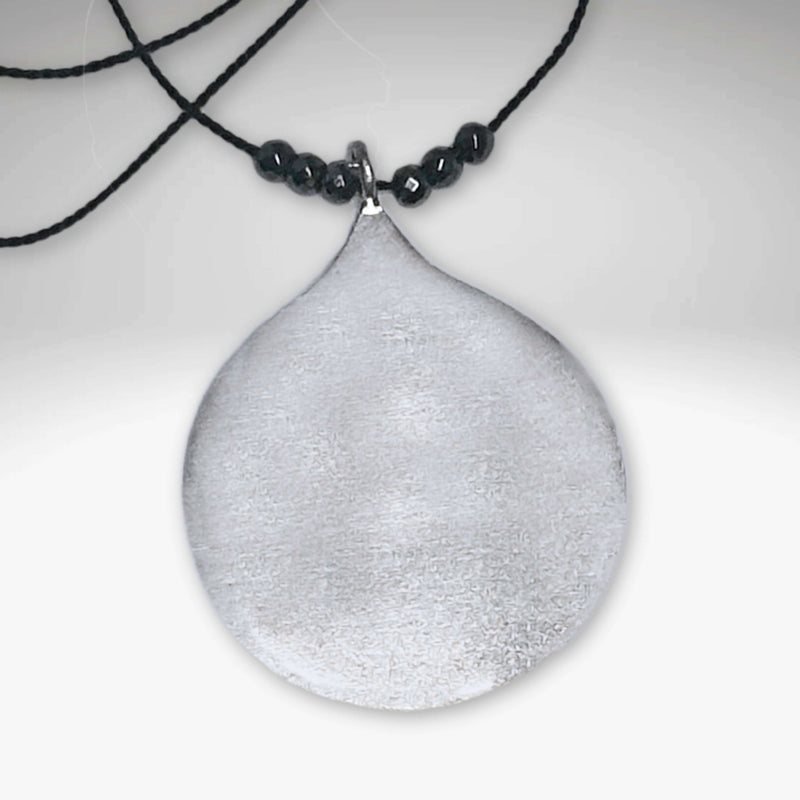 Waterdrop Necklace featuring a larger geometric droplet pendant on delicate silk cord with hematite beads.
