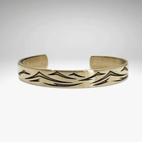 Waves Cuff Bracelet featuring a wave pattern, adjustable fit, available in Matte Silver and Antique Brass finishes.