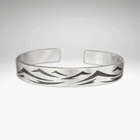 Waves Cuff Bracelet with wave pattern in matte silver finish, adjustable and suitable for all wrist sizes.