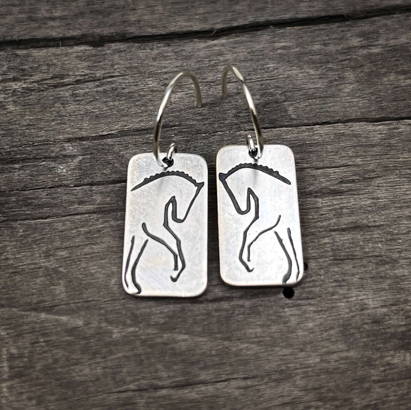 White Horse Dressage Earrings featuring etched silhouettes of powerful horses on brass.