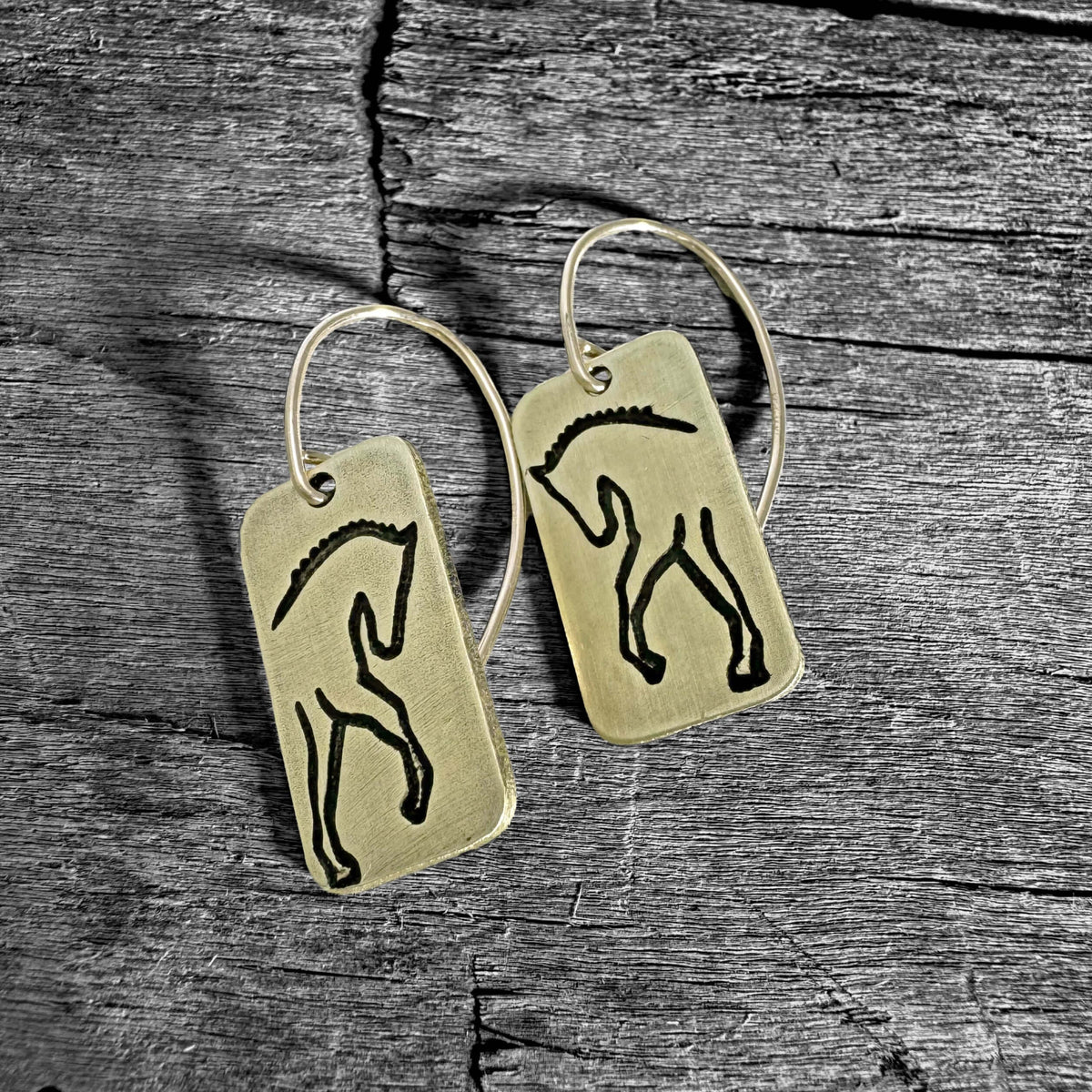White Horse Dressage Earrings featuring etched horse silhouettes on brass.