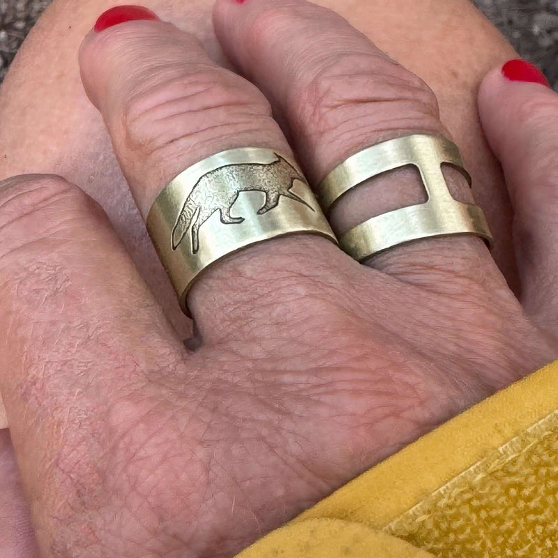 Wide Open Adjustable Ring worn on a hand featuring unique design and finishes in Matte Silver and Antique Brass.