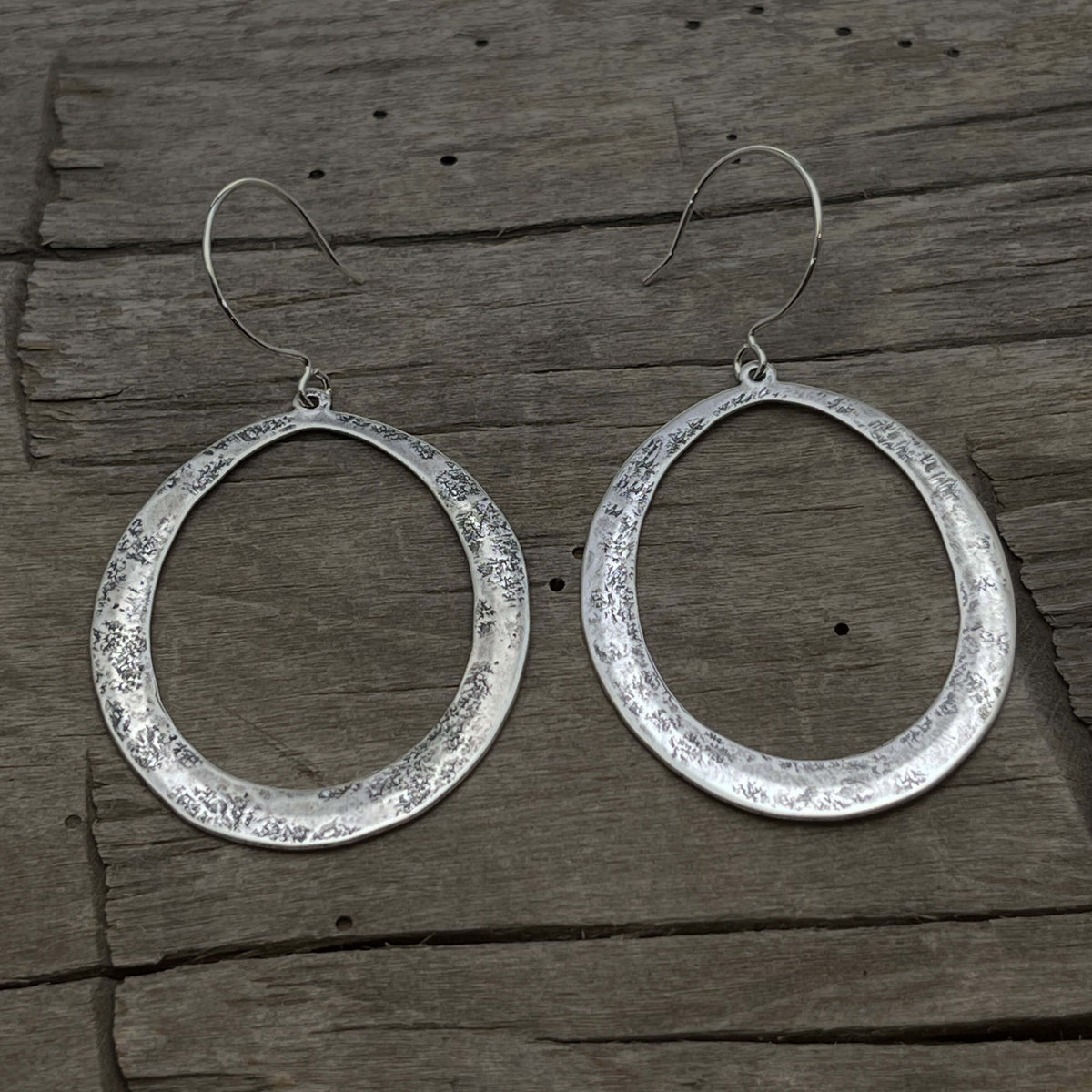 Wide Open Earrings in Matte Silver finish with hammered texture and elegant oval design.
