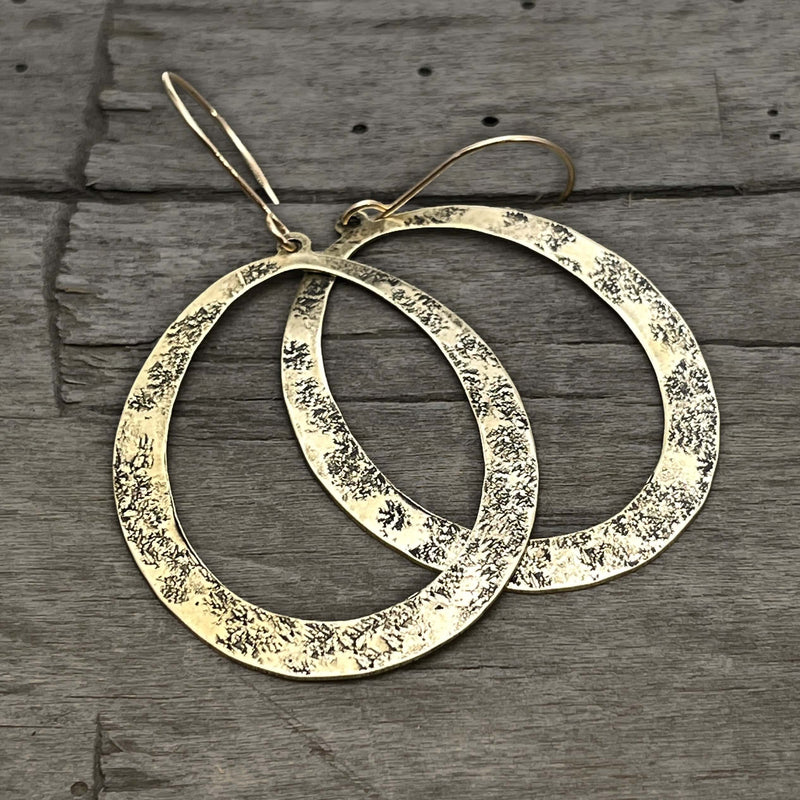 Wide Open Earrings in antique brass finish with textured ovals, perfect for adding elegance to any outfit.