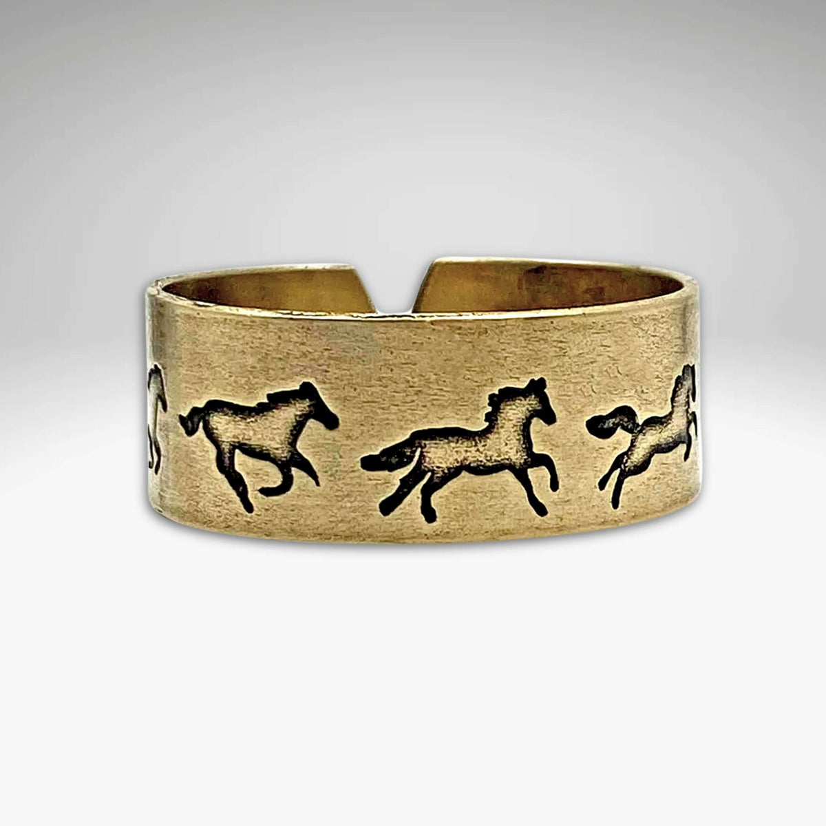 Wild Horses Adjustable Ring featuring galloping mustangs in antique brass finish.