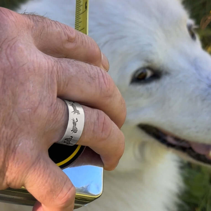 Person wearing the Wild Horses Adjustable Ring next to a fluffy white dog.