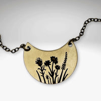 Wildflower Basket Necklace featuring intricate wildflower designs on a brass pendant.